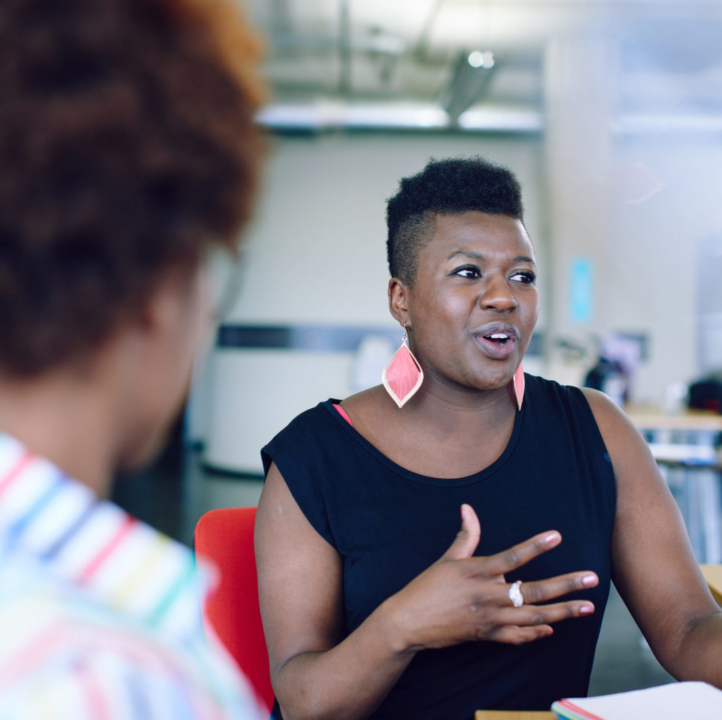 female sitting down talking to unseen colleagues